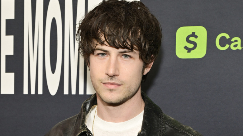 Dylan Minnette wearing a leather jacket