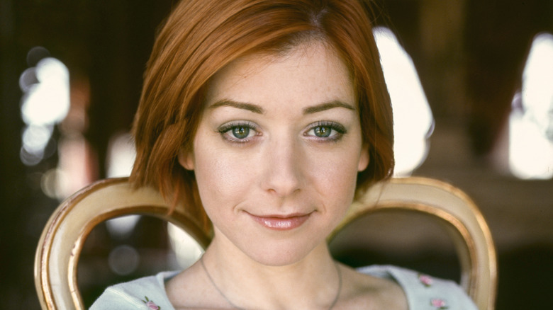 Alyson Hannigan smiling in chair