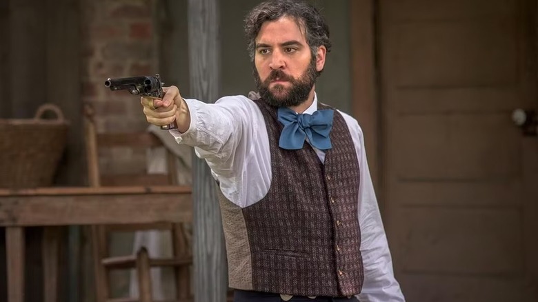 Dr. Jedediah Foster aiming a pistol in Mercy Street