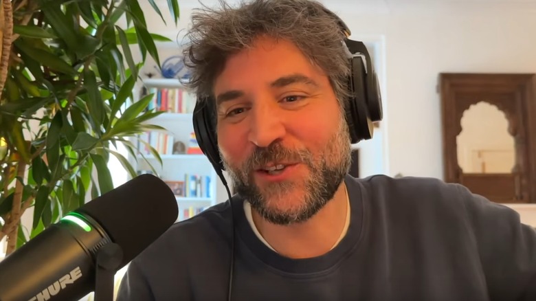 Josh Radnor talking into microphone