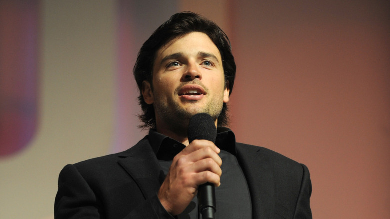 Tom Welling holding a microphone