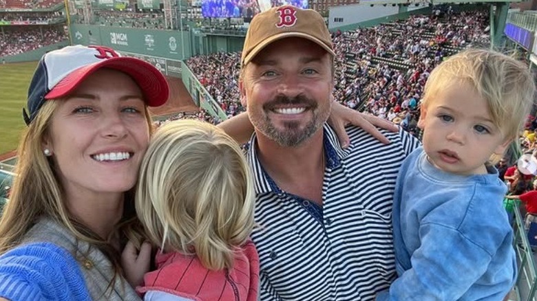 Tom Welling with his wife and children at a baseball game