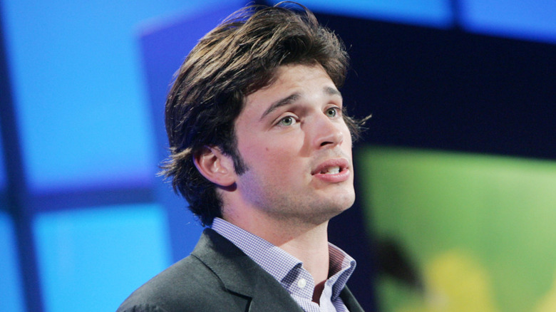 Tom Welling in gray suit talking