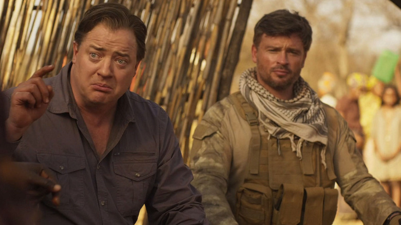 Peter and Vincent sitting in a village in "Professionals" (2020)