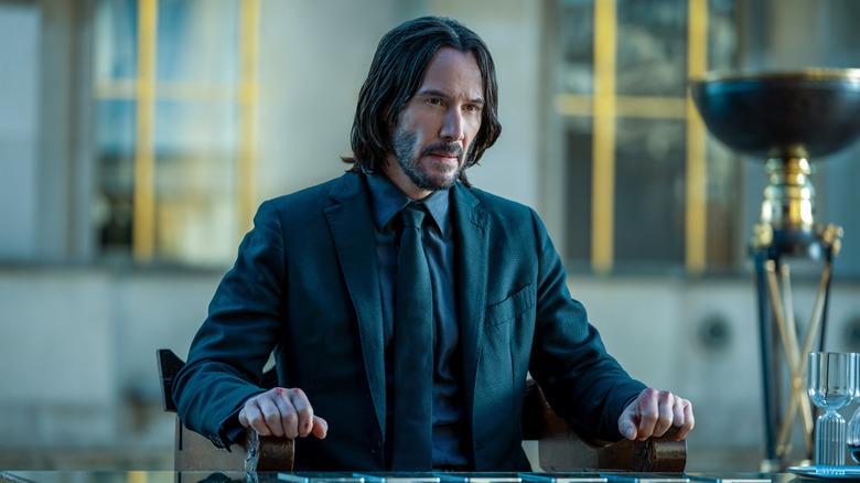 John Wick sitting at table