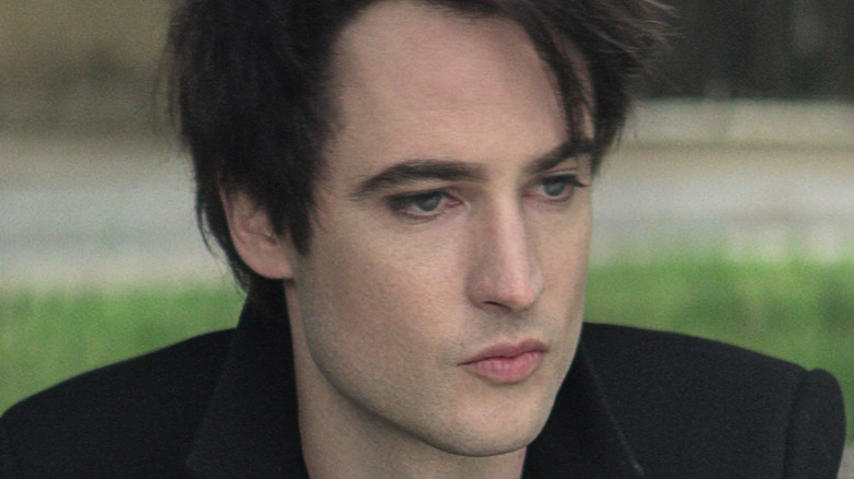 Tom Sturridge as Dream looking thoughtful.