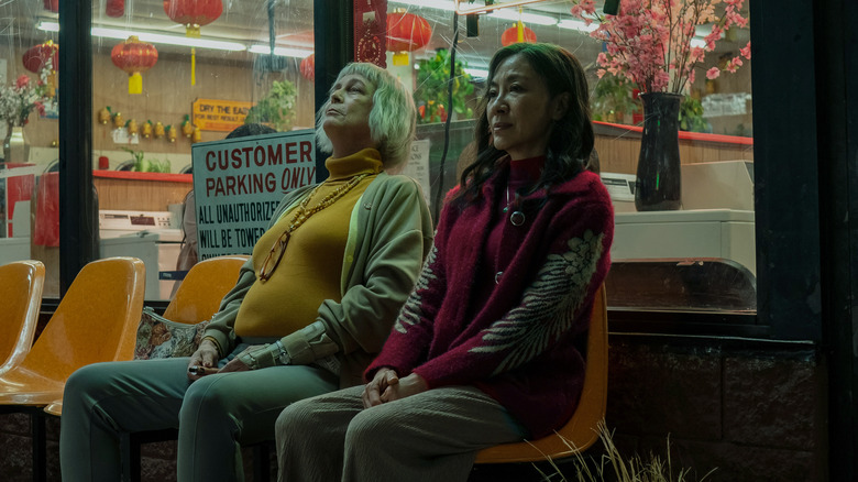 Curtis and Yeoh sit on bench