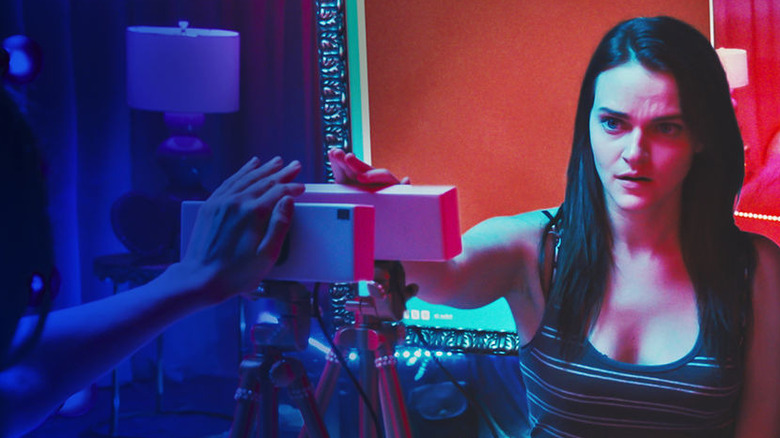 Alice watching cam Lola on screen