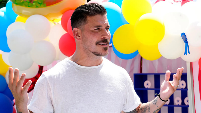 Jax talking in front of balloons on The Valley