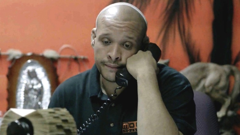 Moco Ruiz holding telephone