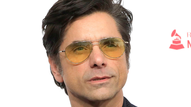 John Stamos posing for pictures