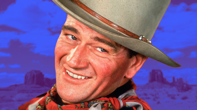 John Wayne smiling and wearing a cowboy hat