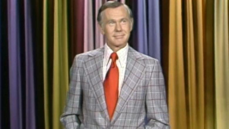 Johnny Carson stands on stage and smiles in The Tonight Show Starring Johnny Carson