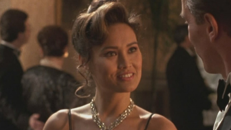Tia Carrere as Juno Skinner in a black dress in True Lies
