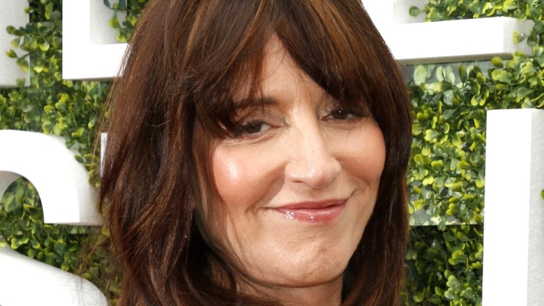 Katey Sagal smiling green background