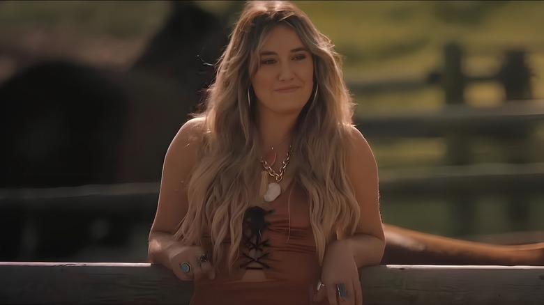 Abby leans against the fence