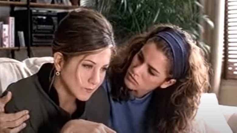 Amanda Peet hugging Jennifer Aniston
