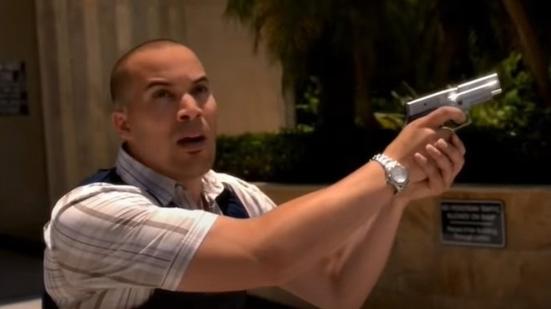 Coby Bell holding gun