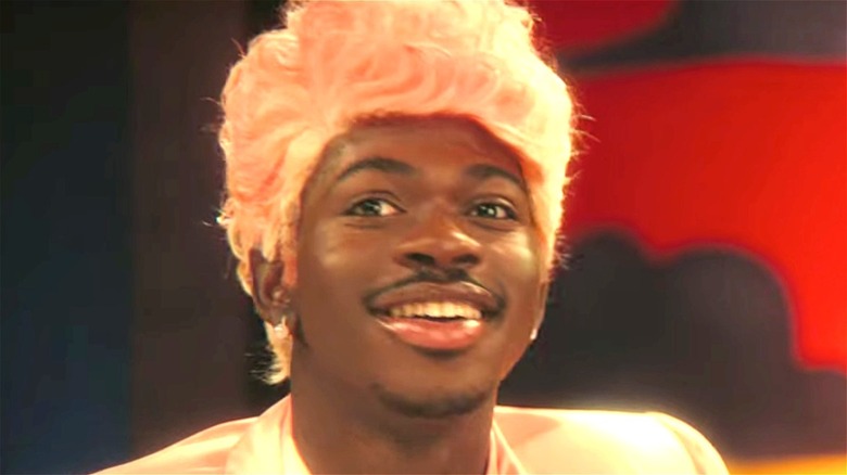 Lil Nas X smiling with cotton candy pink hair