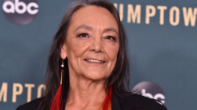 Tantoo Cardinal smiling red earriings