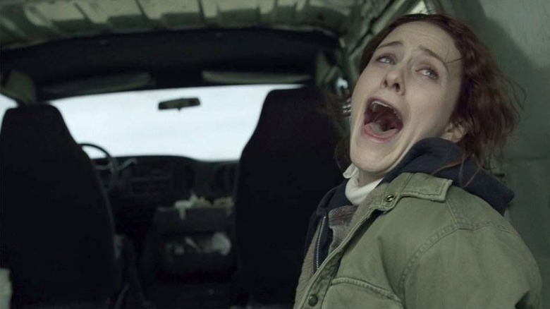 Rachel Posner screams in the back of a car in 