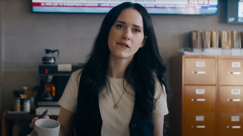 Lois Lane bites her lip in the Daily Planet office in 