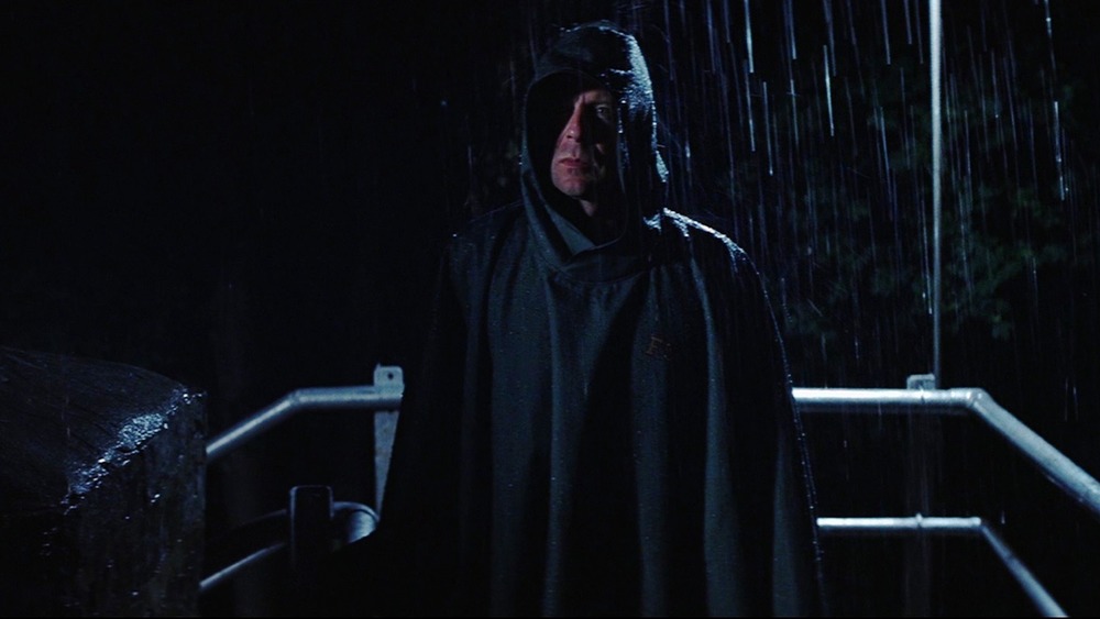 Bruce Willis standing in rain as David Dunn in Unbreakable