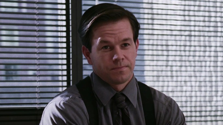 Dignam leaning against window