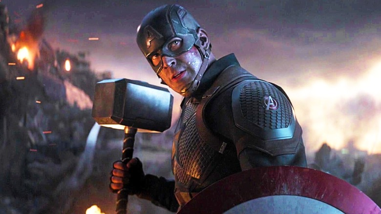 Captain America holding Thor's hammer