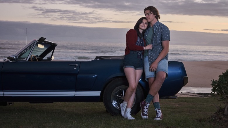 Meganne and Eli leaning car sunset