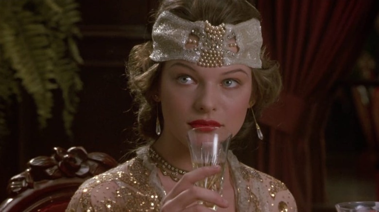 Milla Jovovich drinking