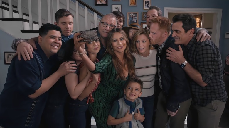 The cast of Modern Family taking a selfie in character