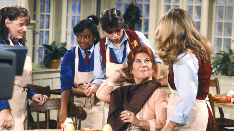 Mrs. Garrett, sitting, with the four main girls standing around her