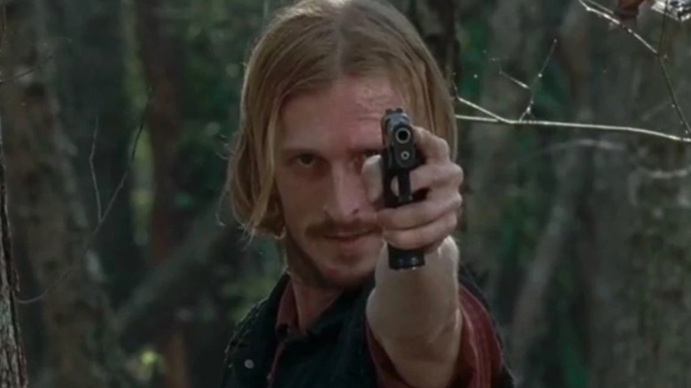 Dwight aims his gun in The Walking Dead