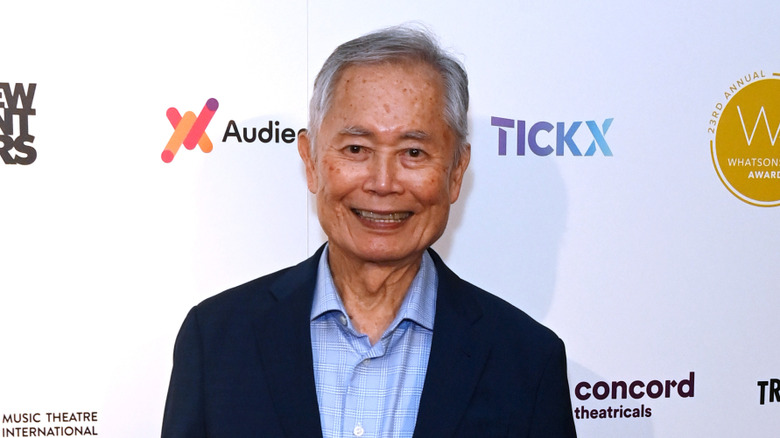 George Takei smiling wearing blazer