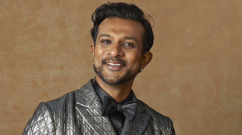Utkarsh Ambudkar smiling wearing suit