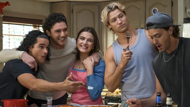 Tucker, Garrett, Hannah, Dean, and Logan standing together around a kitchen counter in 