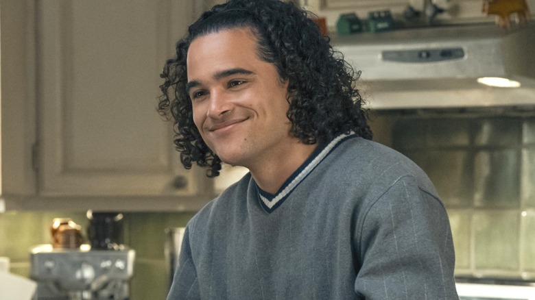 Tucker smiling in the kitchen in "Off Campus"