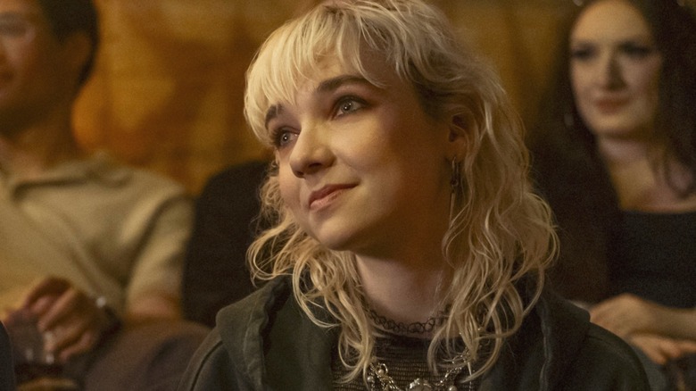 Jules sitting with a blank face in "Off Campus"
