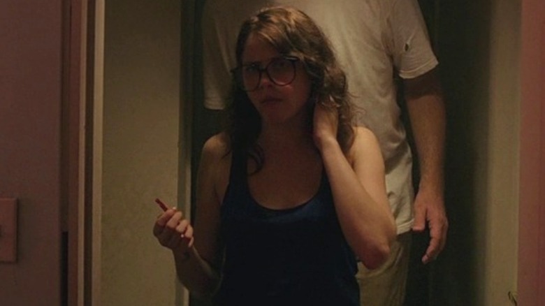 Luccardi standing in doorway with man behind her