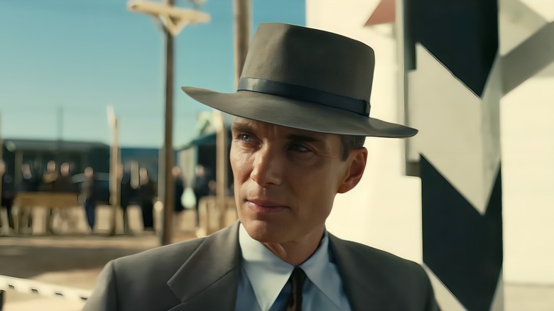 Oppenheimer stands next to a security barrier
