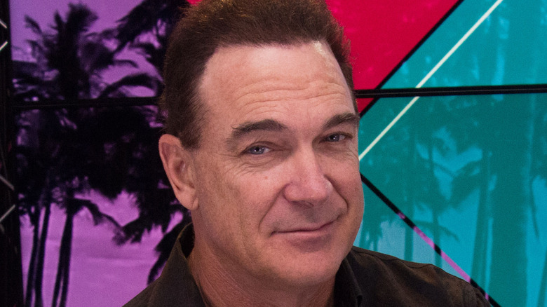 Patrick Warburton smiling into camera