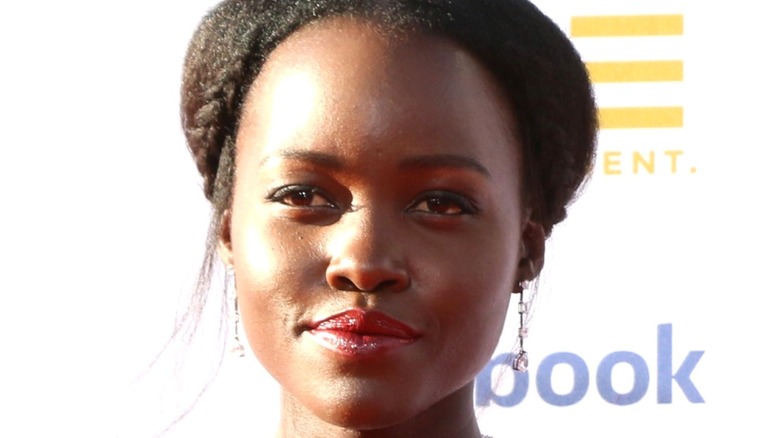 Lupita Nyong'o smiling for press