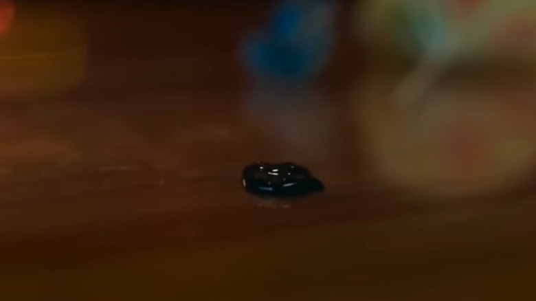 Venom symbiote on countertop in Spider-Man: No Way Home
