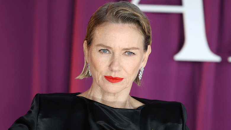 Naomi Watts wearing black dress and red lipstick
