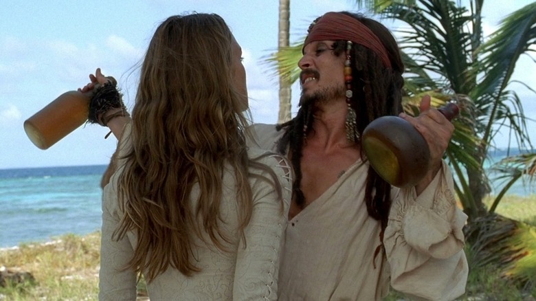 Jack Sparrow holding bottles of rum