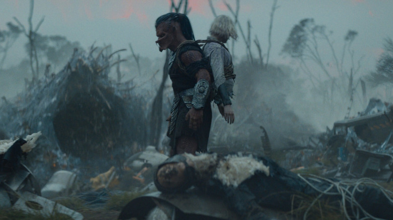 Dek and Thia wandering a battlefield in Predator: Badlands (2025)