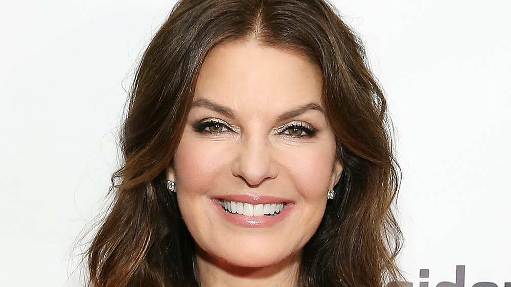 Sela Ward smiling for cameras at a premiere