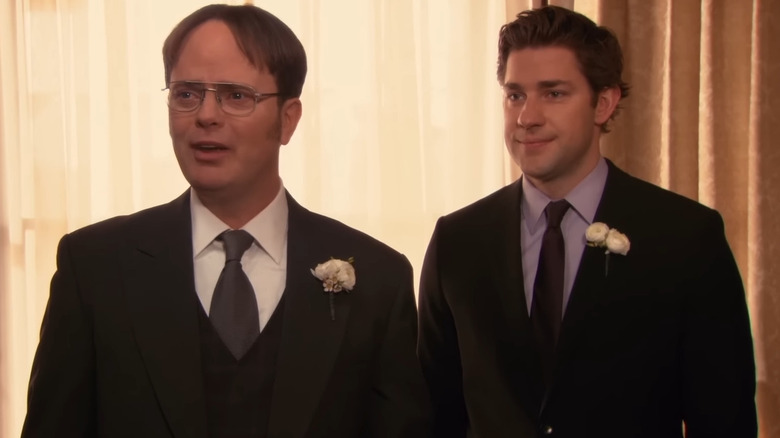 Dwight Schrute (Rainn Wilson) standing next to Jim Halpert (John Krasinski) in The Office