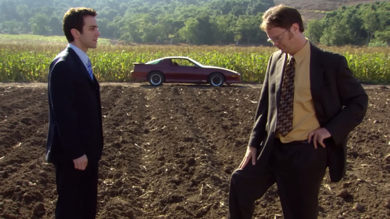Dwight (Rainn Wilson) and Ryan (BJ Novak) standing and talking outside in The Office